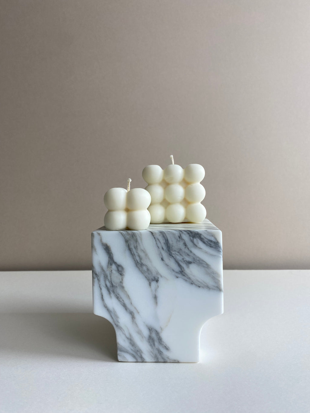 Atelier Ethos Pair Of Bubble Cube Candles Playful and sculptural, a candle pair in natural soy wax combines modern artistry with sustainable luxury. 10% of profits are donated to charity. £12.00