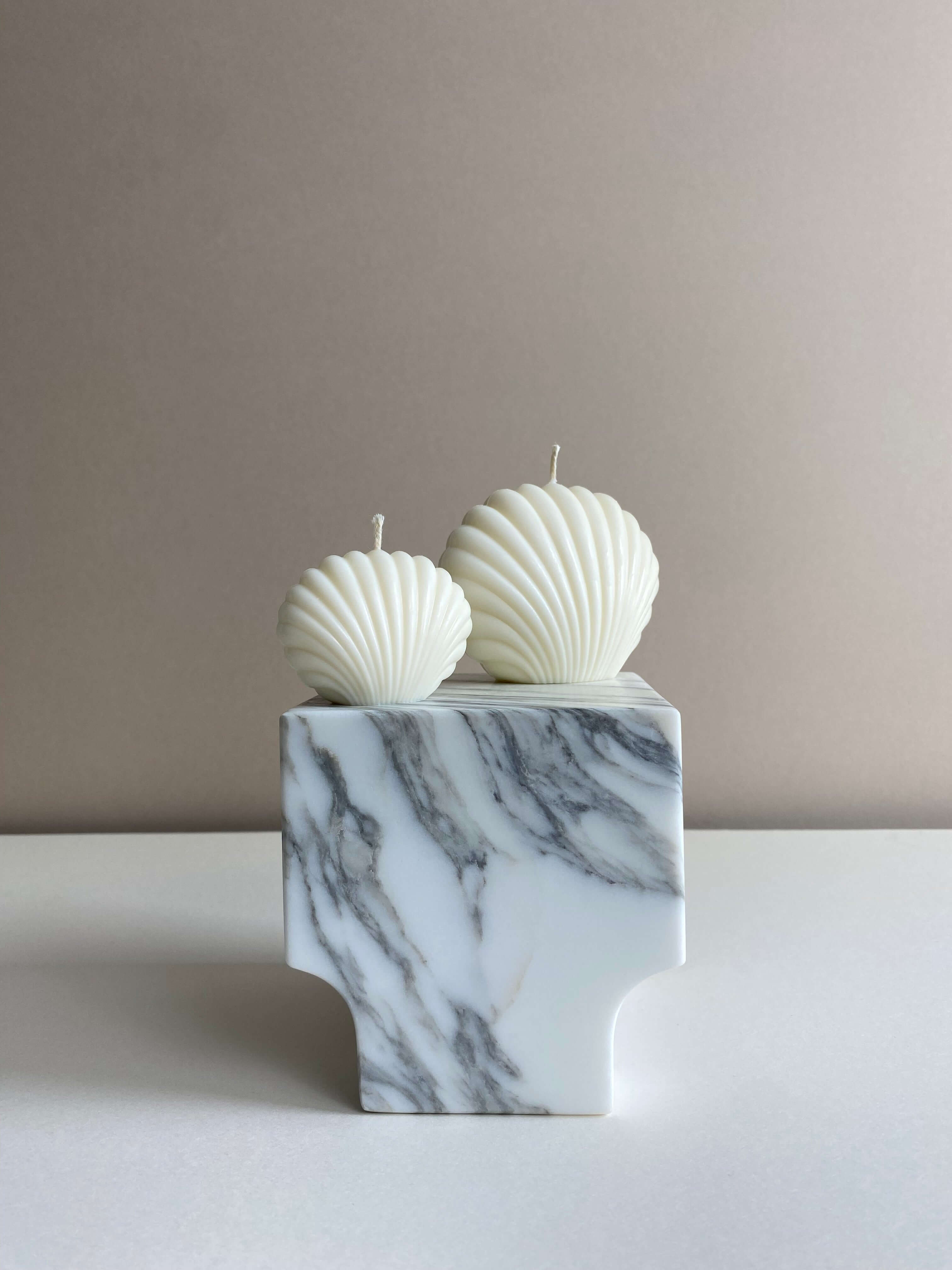Atelier Ethos Pair Of Seashell Candles Evoking coastal elegance, a candle pair in natural soy wax offers sculptural artistry. Sustainable, luxurious, with 10% of profits supporting charity. £11.00